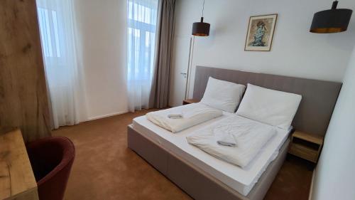 a bedroom with a bed with two white pillows at DOHNANYI Villa by CHORS in Trenčín