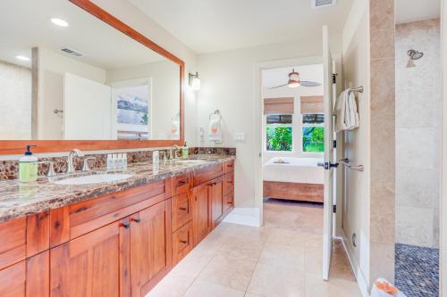 a bathroom with two sinks and a shower at Pili Mai 1A in Koloa
