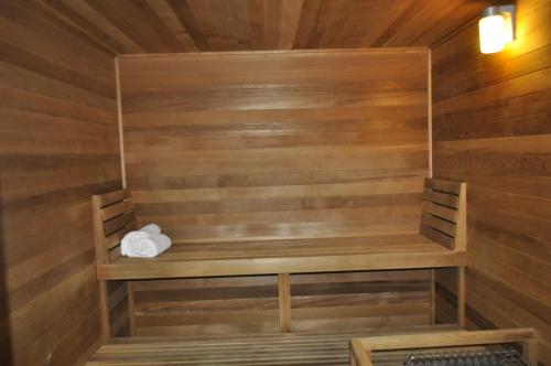 a sauna with wooden walls and a wooden bench at Rocklin Park Hotel, Trademark Collection by Wyndham in Rocklin