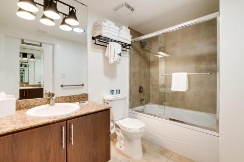 a bathroom with a sink and a toilet and a shower at Ocean View Balcony steps from Restaurants, Peacock Park & Marina in Miami