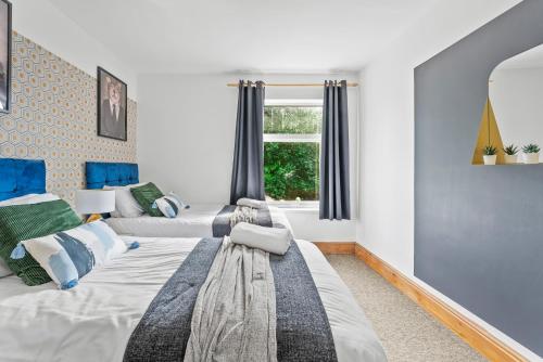 a bedroom with two beds and a window at Large Stylish Home - Close to The City - Garden in Spon End