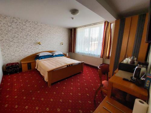a hotel room with a bed and a window at Morena 203 in Klaipėda