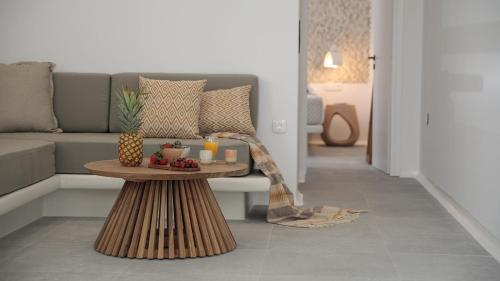 a living room with a couch and a table with candles at Hora Seaside Suites in Naxos Chora