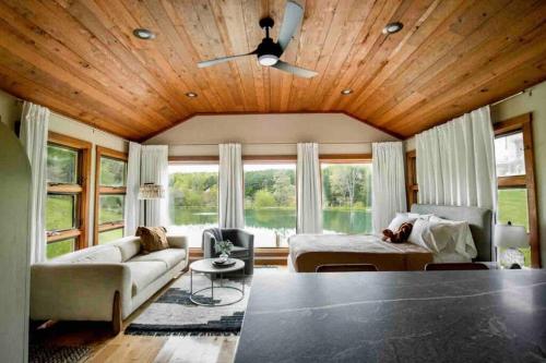 a living room with a couch and a bed at Lake with Dock and Hot Tub Hocking Hills Cabin in Rockbridge