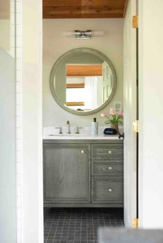 a bathroom with a sink and a mirror at Lake with Dock and Hot Tub Hocking Hills Cabin in Rockbridge