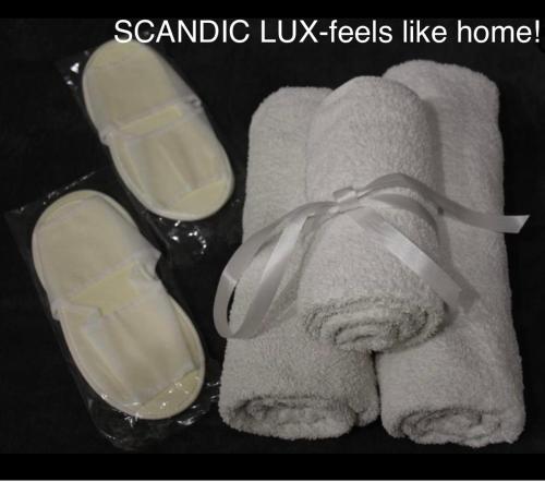 a pair of towels and a pair of glasses on a towel at SCANDIC-LUX apartments-feels like home! В центрі Львова in Lviv