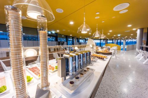 a buffet area of a restaurant with food on display at Prize by Radisson, Bonn City in Bonn
