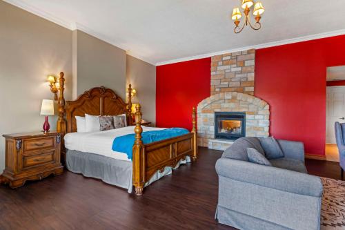 a bedroom with a bed and a fireplace and a couch at Christie's Mill Inn & Spa - BW Premier Collection in Port Severn