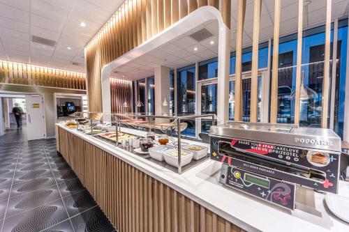 a buffet line in a restaurant with food at prizeotel Antwerp-City in Antwerp