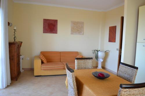 a living room with a table and a couch at Villa Bella Vista in Santa Domenica