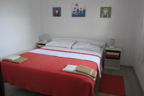 a bedroom with a bed with two towels on it at Holiday Home Mirta in Pakoštane