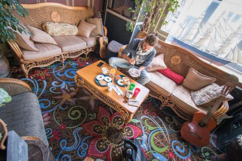 a young boy sitting on a couch in a living room at Green Tortoise Hostel in San Francisco