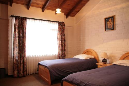 Llit o llits en una habitació de Apartamentos Los Quipus