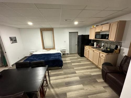 a room with a bed and a couch and a kitchen at windrock ridge - Ethan in Oak Ridge