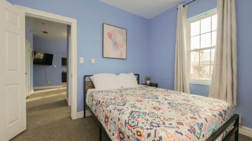 a blue bedroom with a bed and a window at Atlantic Suite by the Boardwalk 2D in Atlantic City