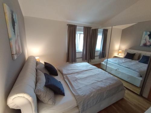 a living room with a couch and a bed at Apartment Anita in Umag