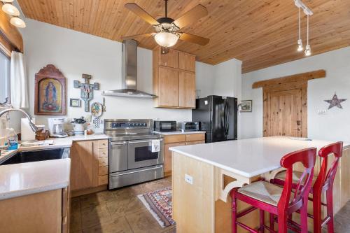 a kitchen with wooden cabinets and a ceiling fan at Casa de Luna in Alpine