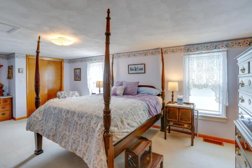 a bedroom with a four poster bed and a window at Home with Screened-In Porch Less Than 1 Mi to Lake Erie in Port Clinton