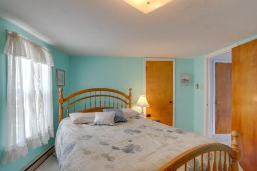 a bedroom with a large bed with blue walls at Home with Screened-In Porch Less Than 1 Mi to Lake Erie in Port Clinton