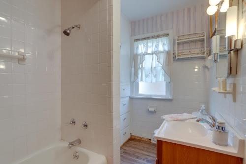 a bathroom with a tub and a sink and a shower at Home with Screened-In Porch Less Than 1 Mi to Lake Erie in Port Clinton