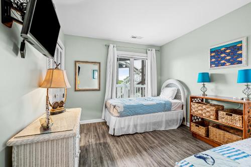 a bedroom with two beds and a window at Colony by the Sea #201 in Indian Beach