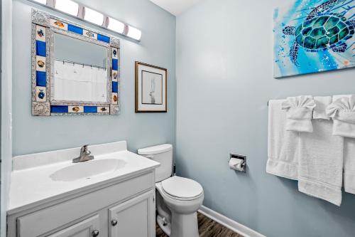 a white bathroom with a sink and a toilet at IBCS02 Colony by the Sea #201 in Indian Beach