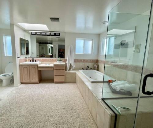 a bathroom with a tub and a sink and a shower at Beach House located in quiet community. in Oxnard
