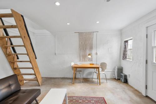 a living room with a table and a staircase at Studio 410 in Alpine