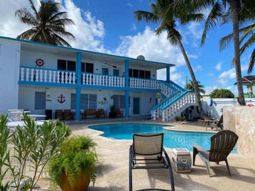 a house with a swimming pool in front of it at The Beach Guesthouse in Pinones