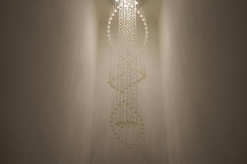 a white chandelier hanging from a wall at Novana Aparthotel in Glasgow