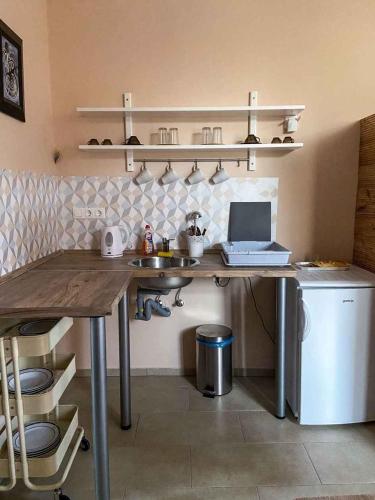 a kitchen with a desk with a laptop on it at Holiday home in Heviz - Balaton 44882 in Hévíz