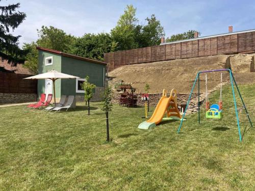 a yard with a playground with slides and swings at Holiday home in Heviz - Balaton 44882 in Hévíz