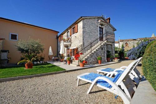 a group of chairs sitting in front of a building at Apartment in Baderna - Istrien 44223 in Baderna