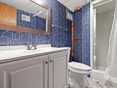 a bathroom with a white sink and a toilet at Convenient 5 bedroomMetro Milwaukee Brewers! in West Allis