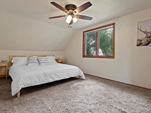 a bedroom with a bed and a ceiling fan at Convenient 5 bedroomMetro Milwaukee Brewers! in West Allis