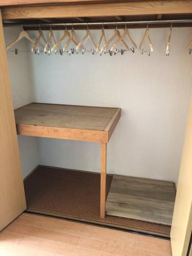 a closet with a wooden table and some hangers at Chichibu Mizuno-stay 水野ステイ最大６名様 in Chichibu