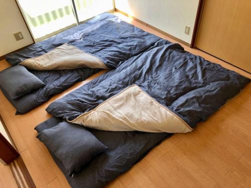 a pile of sleeping bags sitting on the floor at Chichibu Mizuno-stay 水野ステイ最大６名様 in Chichibu