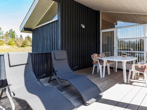 a porch with a table and chairs on a deck at 6 person holiday home in Pandrup-By Traum in Pandrup