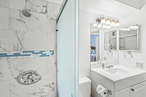 a white bathroom with a shower and a sink at Beautiful Condo at Kihei Ali'i Kai, Close to Beach in Kihei