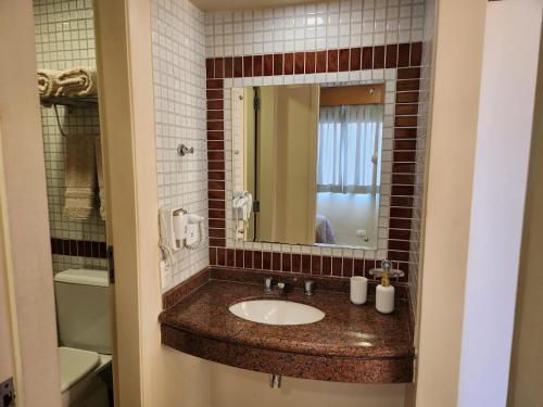 a bathroom with a sink and a mirror at Residence Flat 143 em Santana in Sao Paulo