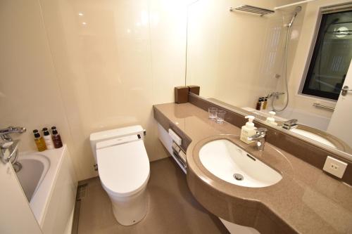 a bathroom with a white toilet and a sink at K-style 東本願寺 in Kyoto
