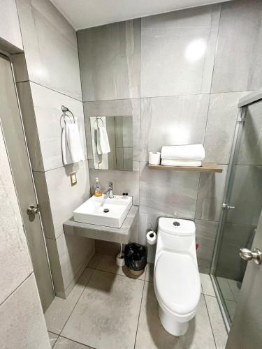 a bathroom with a toilet and a sink at 5010 depa Pacifika de lujo en Marina Mazatlán in Mazatlán