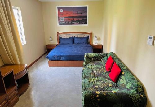 a bedroom with a bed and a couch in it at Aladdin Dream Hotel in Johor Bahru