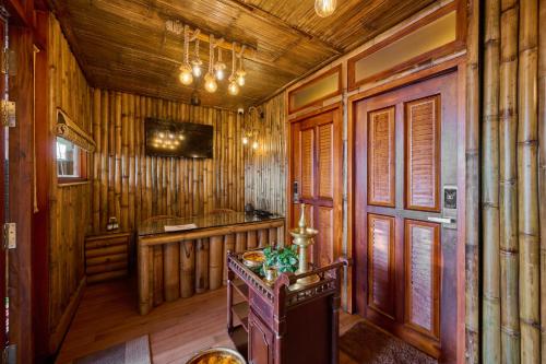 a wooden room with a sink and a table in it at Maliekal Heritance Cherai Beach Cochin in Cherai Beach