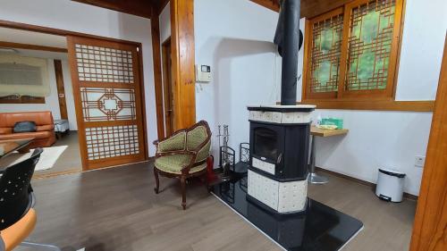 a living room with a wood stove in a room at Ever Healing House in Namugil