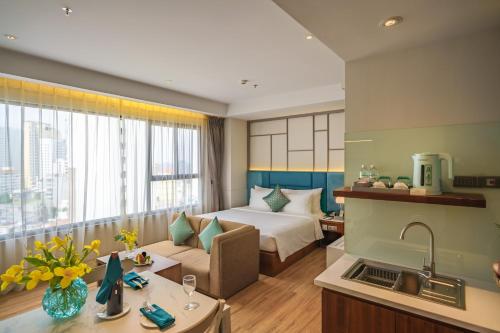 a hotel room with a bed and a kitchen at Seaesta Nha Trang Hotel in Nha Trang