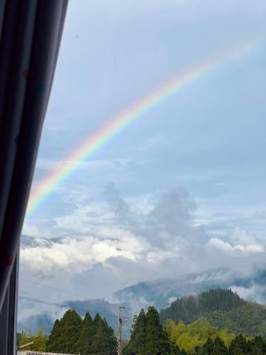 a rainbow in the sky over a mountain at Yun pu cha jan in Fanlu