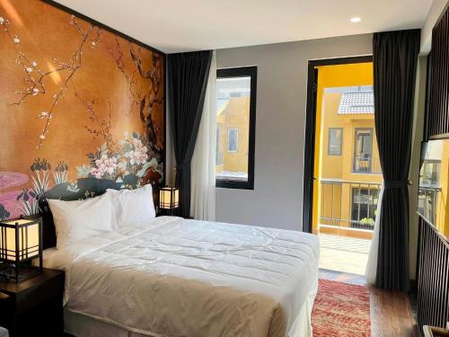 a bedroom with a bed and a large painting on the wall at Wyndham Thanh Thủy in Chú Mật