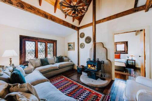 a living room with a couch and a fireplace at Apple Tree Cottage - An Idyllic Country Reset in Eurunderee