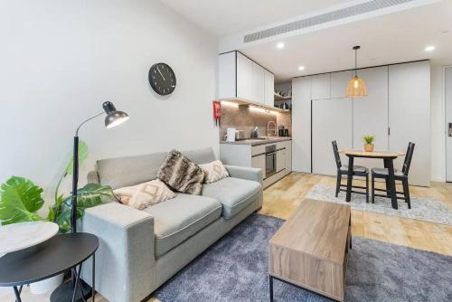 a living room with a couch and a table at Stylish One BD Hideaway in Essendon in Melbourne
